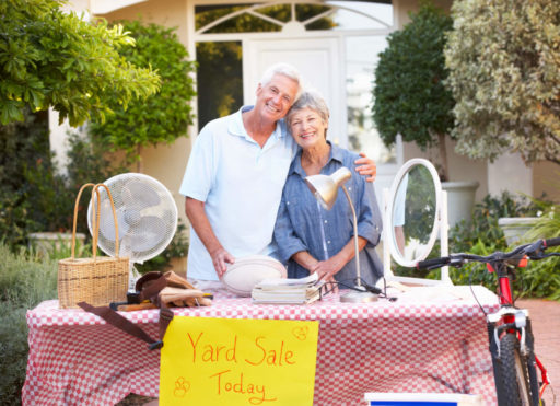 Tips for Downsizing to Senior Living Older couple having a garage sale