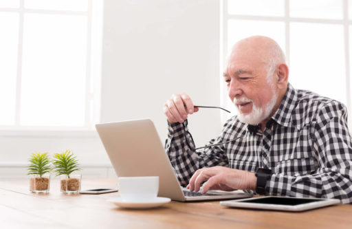 How to find and research senior living communities elder man on laptop
