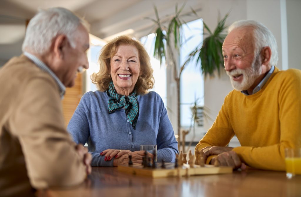 A group of older adults play games together in their assisted living community.